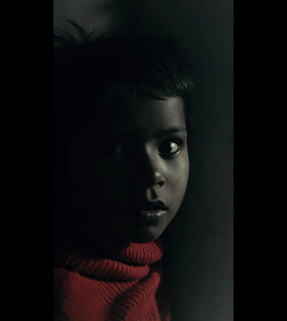 A quiet face in red — one frame, no direction given.